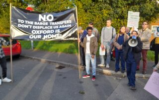 Protesters gather to demonstrate against the barge transfers.