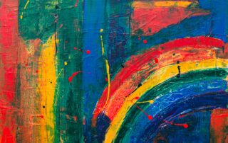 A wall painted in abstract rainbow colours